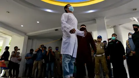 Two gay men are brutally whipped 76 times each in public over same sex relationship photos